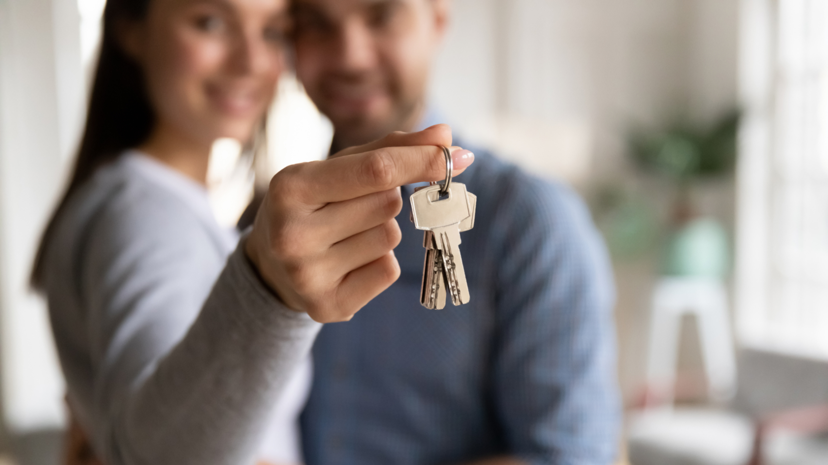 Happy Young Couple Holding Keys