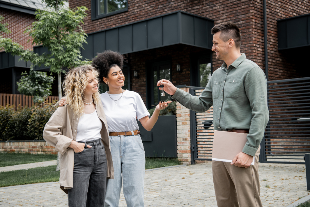 Happy Young Couple Holding Keys